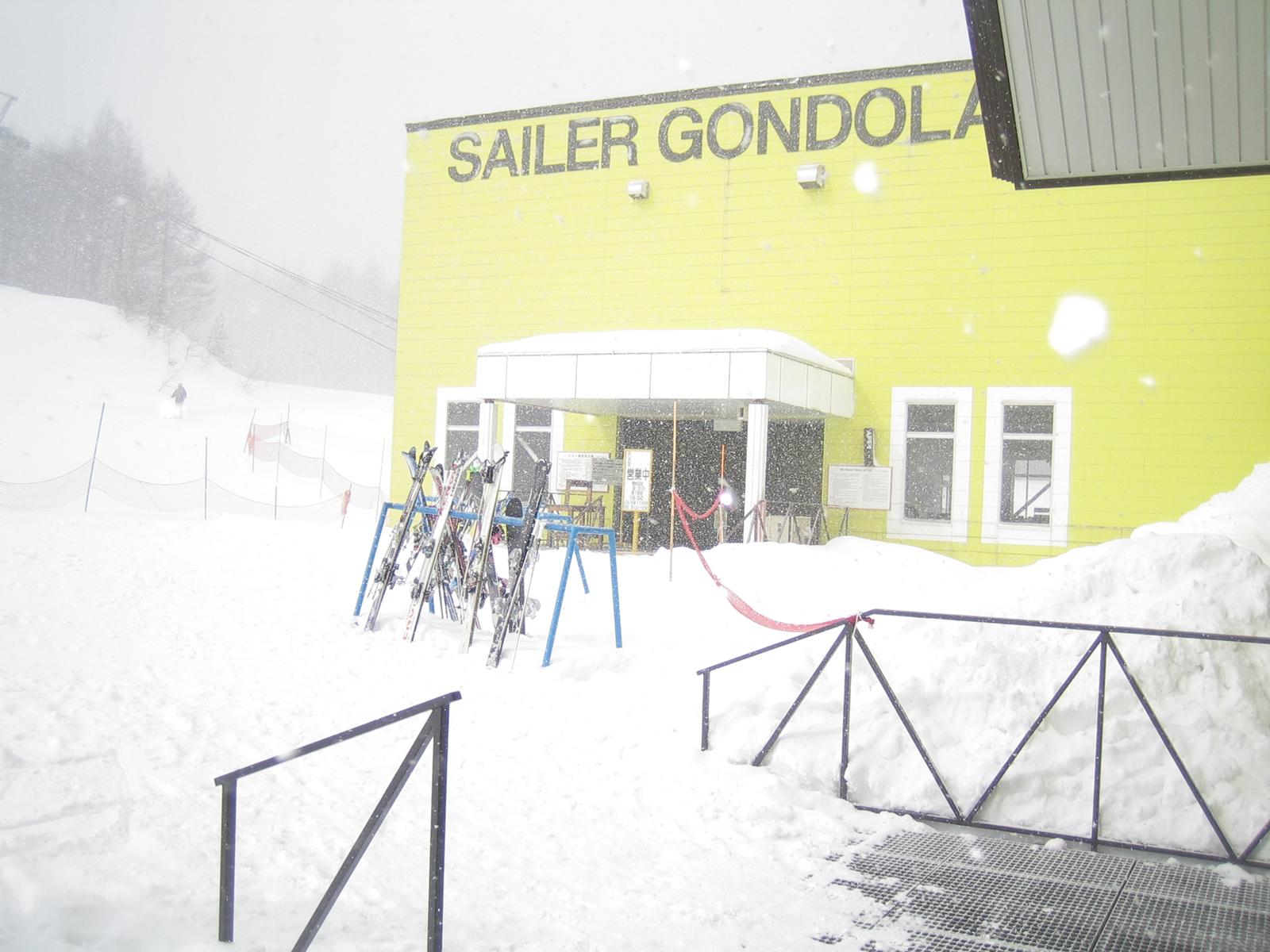 暴風雪中的黃色 Sailer Gondola 纜車站與雪具架