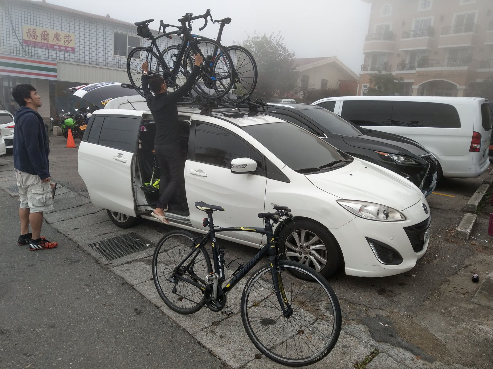 清晨清境晨霧中自小客車車頂架卸車組裝美利達公路車